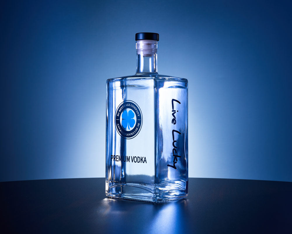 BC Beverage Company Premium Vodka with blue background on table